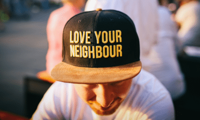 man with a hat stating "love your neighbor"