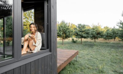 woman in a big house sitting in the window