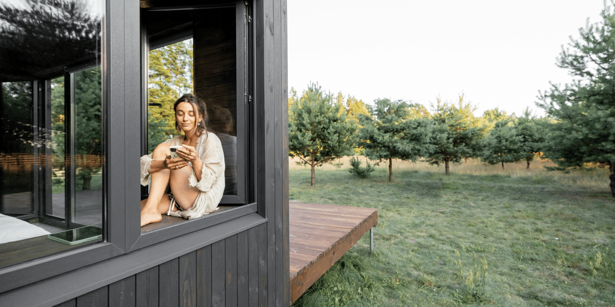 woman in a big house sitting in the window